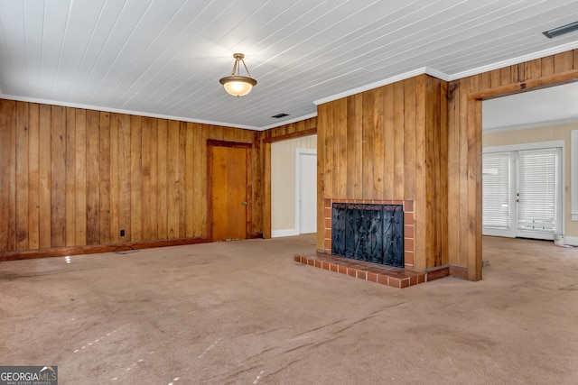 unfurnished living room featuring crown molding, carpet flooring, and wood walls