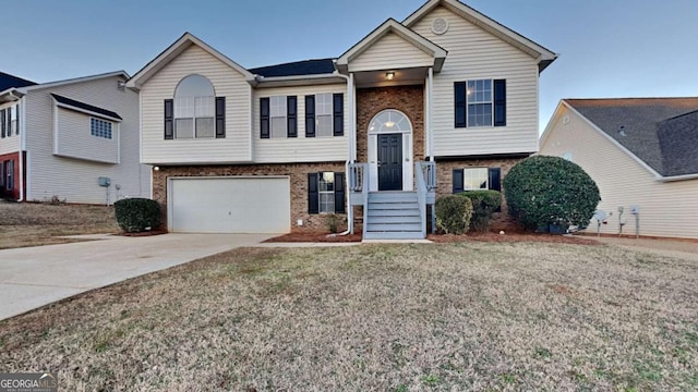 bi-level home featuring a garage and a front yard