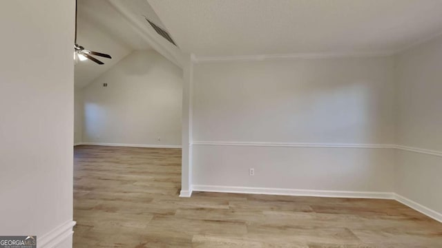 unfurnished room featuring ceiling fan, lofted ceiling, and light hardwood / wood-style floors