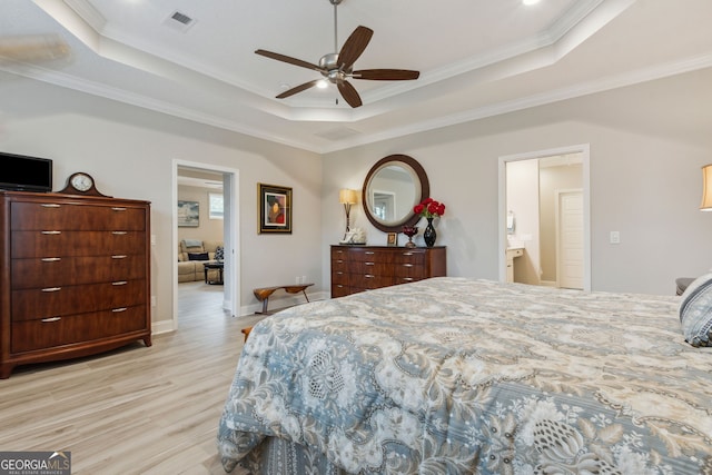 bedroom featuring crown molding, ceiling fan, light wood-type flooring, and a tray ceiling