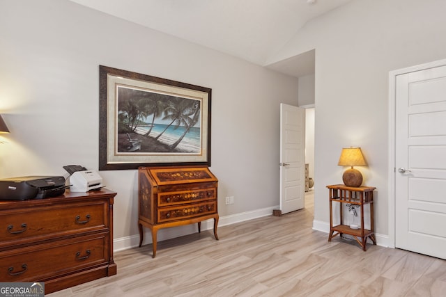 sitting room with light hardwood / wood-style floors and vaulted ceiling