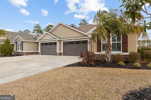 view of front of home with a garage and a front yard