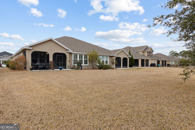 back of house featuring a yard