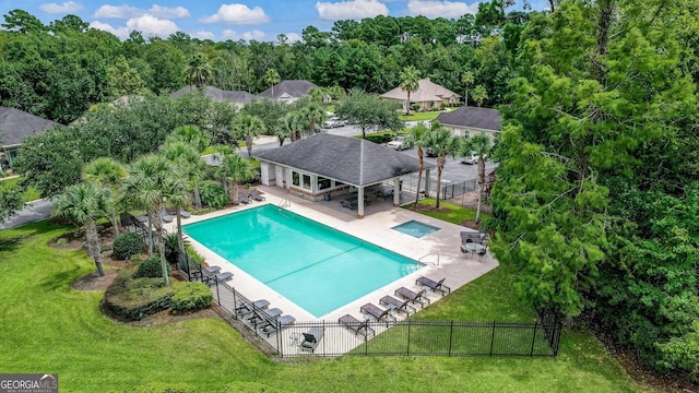 view of swimming pool featuring an outdoor structure, a yard, and a patio area