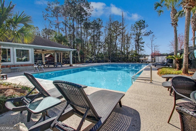 view of pool featuring ceiling fan and a patio