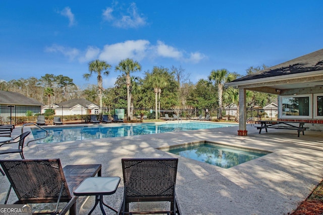 view of swimming pool with a patio area and an in ground hot tub