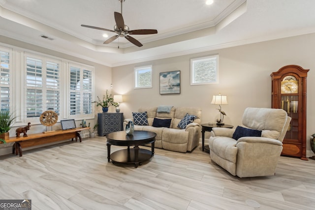 living room with crown molding, a raised ceiling, and ceiling fan