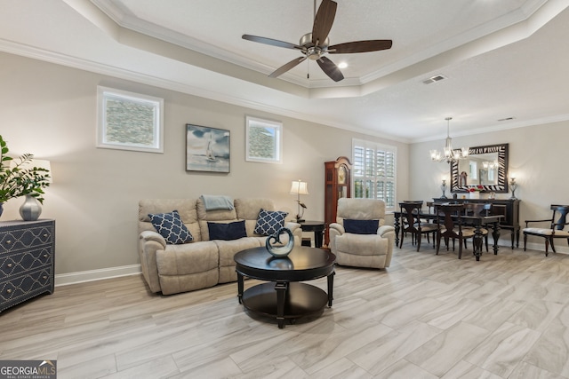 living room with a raised ceiling, crown molding, and ceiling fan with notable chandelier