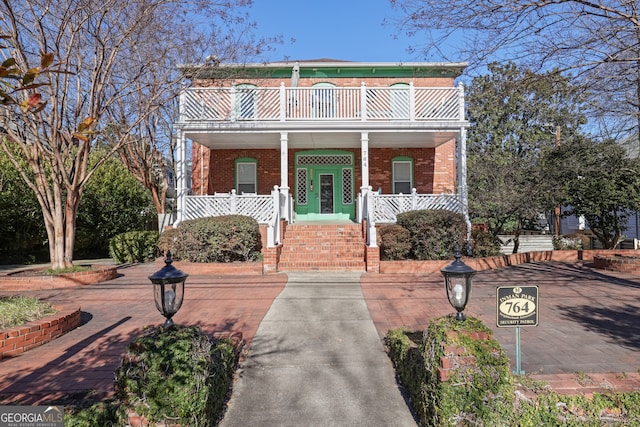 front of property with a balcony and covered porch