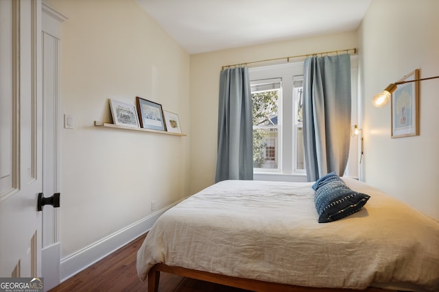 bedroom featuring dark wood-type flooring