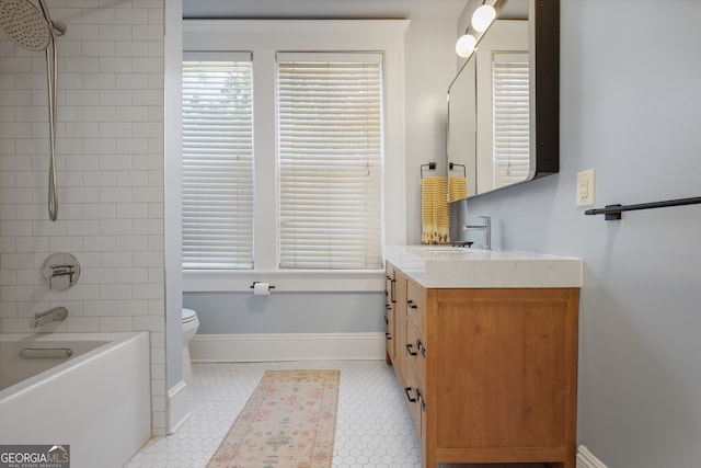 full bathroom featuring tiled shower / bath combo, vanity, tile patterned floors, and toilet