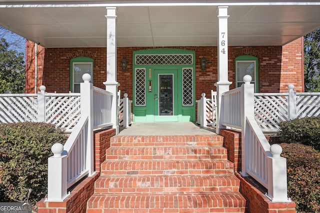 view of exterior entry with covered porch