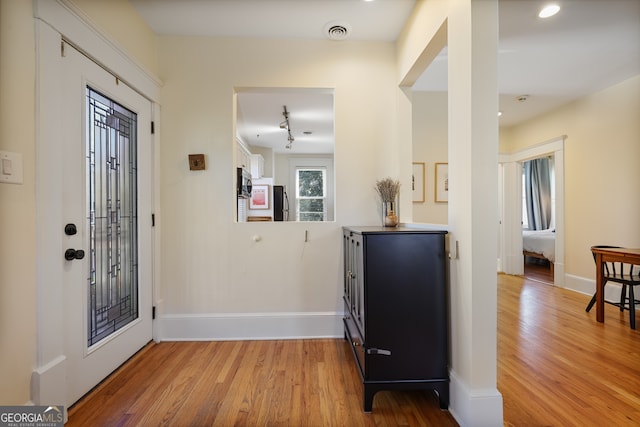 entryway with light hardwood / wood-style floors