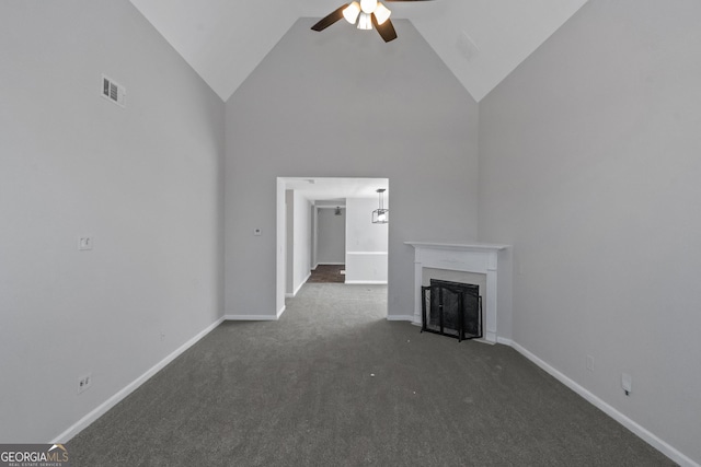 unfurnished living room with dark carpet, high vaulted ceiling, and ceiling fan