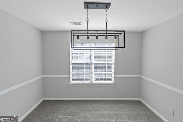 unfurnished dining area featuring carpet flooring