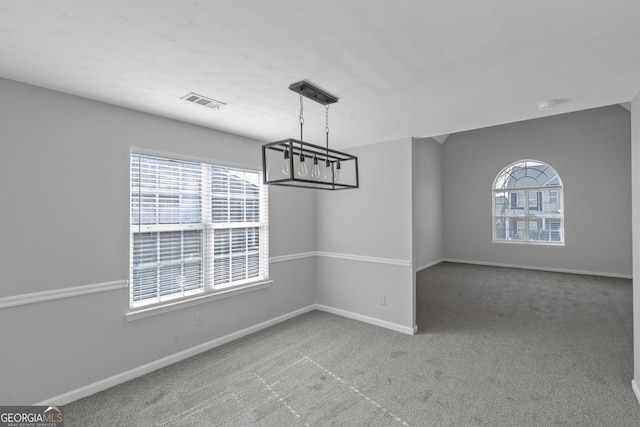 unfurnished dining area with plenty of natural light and carpet flooring