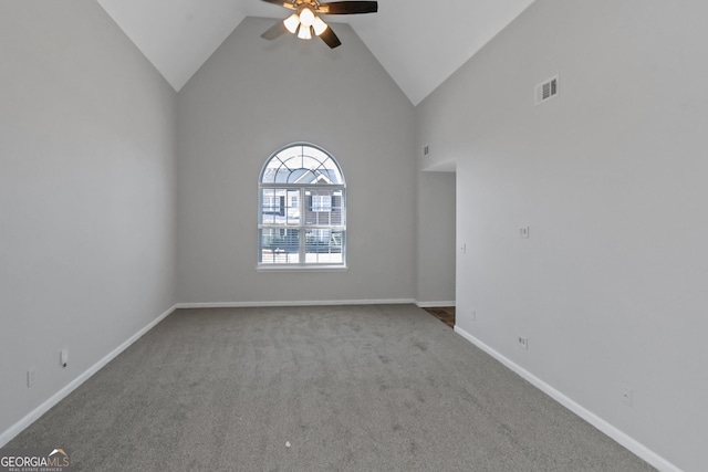 carpeted empty room featuring ceiling fan and high vaulted ceiling