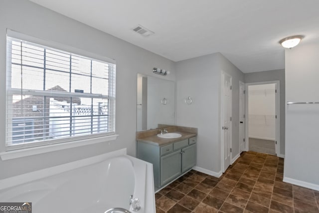 bathroom with vanity and a bathtub