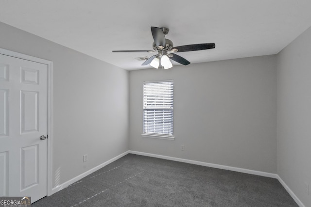 unfurnished room with ceiling fan and dark carpet