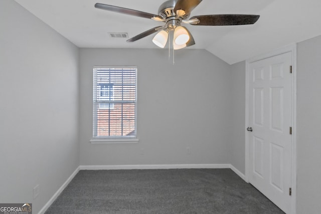 carpeted spare room featuring lofted ceiling and ceiling fan