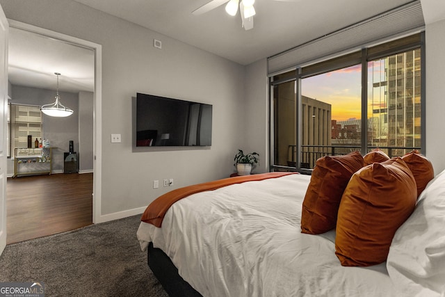 carpeted bedroom featuring access to exterior, a ceiling fan, and baseboards