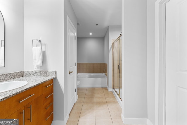 full bathroom with a garden tub, a shower stall, tile patterned flooring, baseboards, and vanity