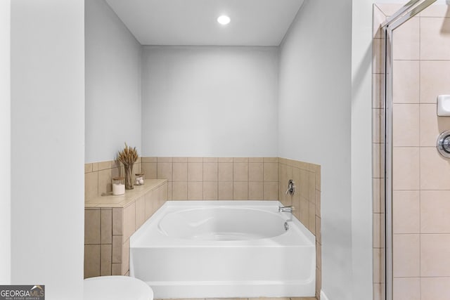 bathroom with a bath, recessed lighting, a shower stall, and toilet