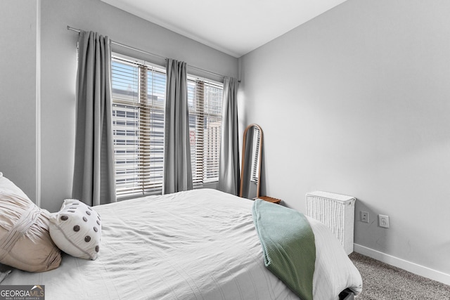 bedroom featuring baseboards and carpet