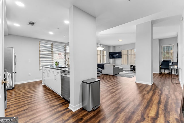 kitchen featuring visible vents, dark countertops, appliances with stainless steel finishes, white cabinets, and dark wood-style flooring