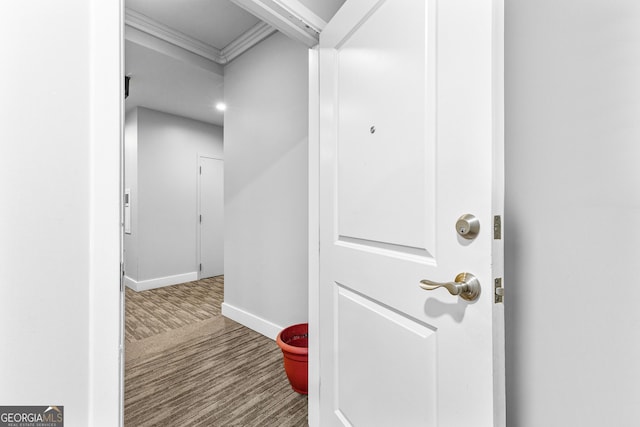 hallway featuring baseboards and wood finished floors