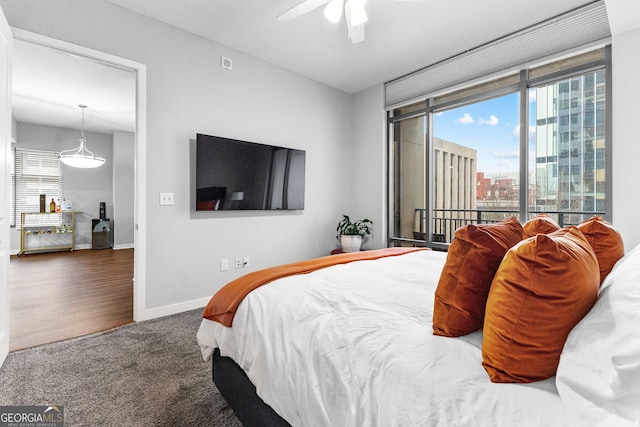 bedroom with baseboards, multiple windows, ceiling fan, and carpet flooring