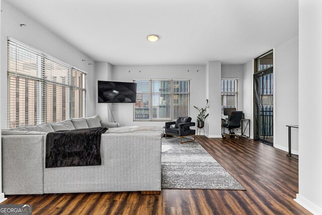 living area featuring wood finished floors and baseboards