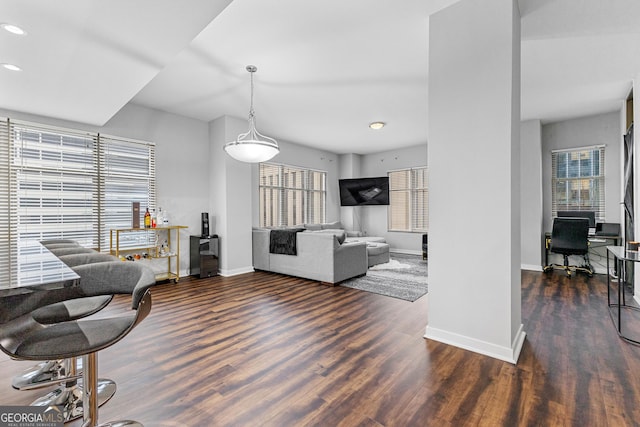 living room with recessed lighting, baseboards, and wood finished floors