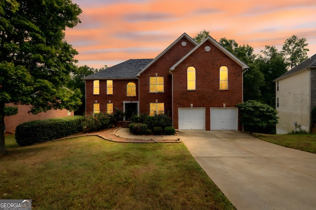 view of front of property featuring driveway, a front yard, a garage, and brick siding