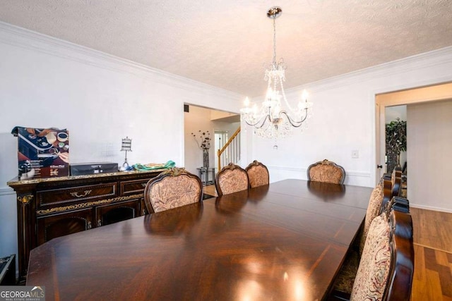 dining space with stairway, an inviting chandelier, ornamental molding, a textured ceiling, and wood finished floors