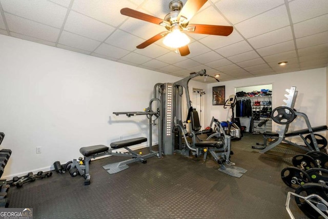 exercise area with ceiling fan and a paneled ceiling