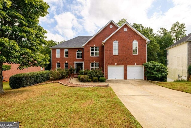 colonial home featuring driveway, brick siding, a front lawn, and an attached garage