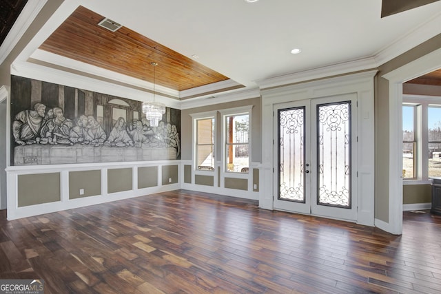 foyer entrance featuring french doors, ornamental molding, dark hardwood / wood-style flooring, and a tray ceiling