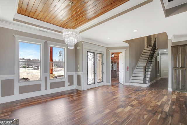 interior space featuring wood ceiling, an inviting chandelier, ornamental molding, a tray ceiling, and dark hardwood / wood-style flooring