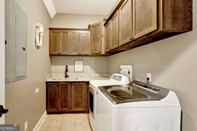 clothes washing area featuring sink, cabinets, light tile patterned floors, washing machine and clothes dryer, and electric panel