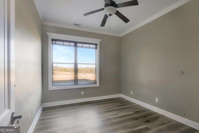 empty room with crown molding, dark wood-type flooring, and ceiling fan