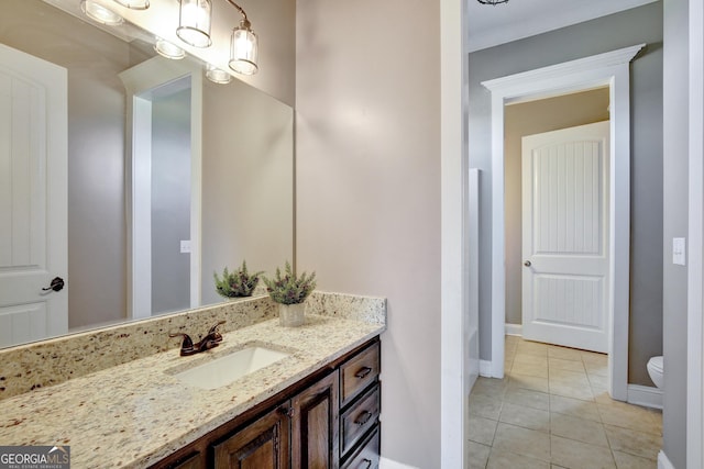 bathroom featuring tile patterned flooring, vanity, and crown molding