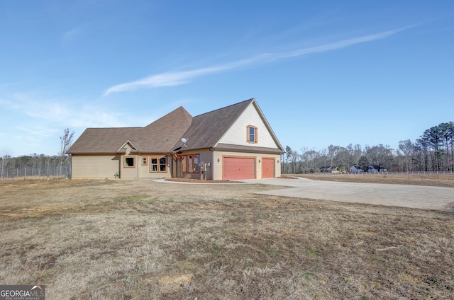 exterior space with a garage and a yard