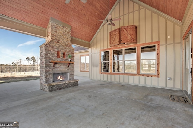 unfurnished living room with ceiling fan, exterior fireplace, wood ceiling, and high vaulted ceiling