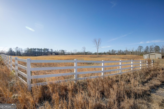 view of yard with a storage unit and a rural view