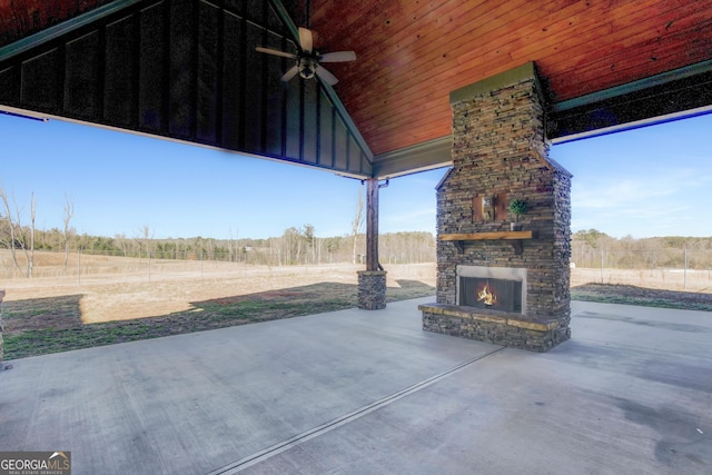 view of patio with ceiling fan and an outdoor stone fireplace