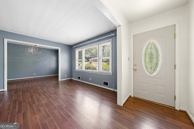 foyer entrance featuring baseboards, visible vents, and dark wood-style flooring