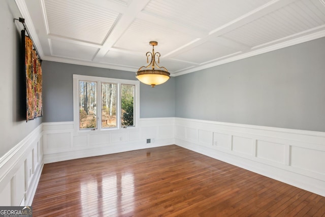 spare room with dark hardwood / wood-style floors and coffered ceiling