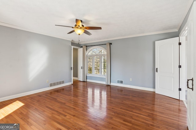 spare room featuring ceiling fan, crown molding, and dark hardwood / wood-style flooring