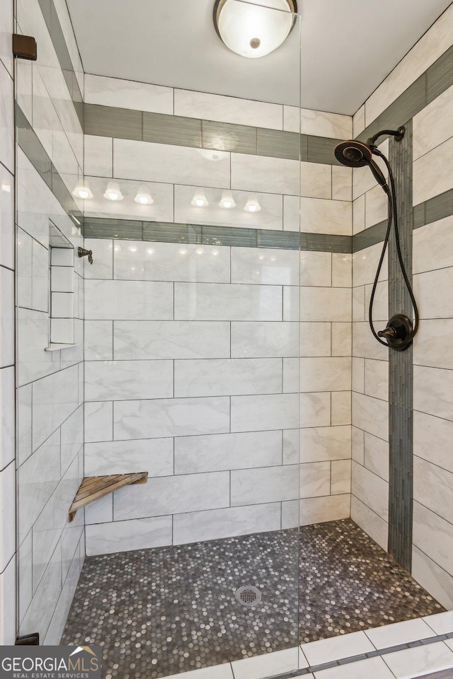 bathroom with tiled shower